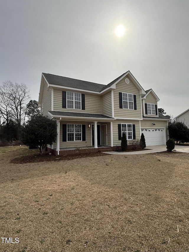 traditional home featuring concrete driveway and an attached garage