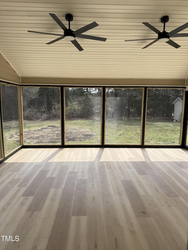 unfurnished sunroom with ceiling fan