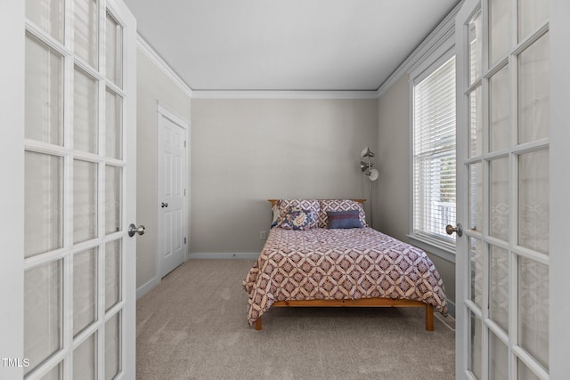 carpeted bedroom featuring crown molding, french doors, and baseboards