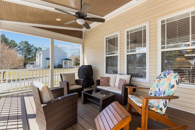 wooden deck featuring outdoor lounge area, a ceiling fan, and a grill