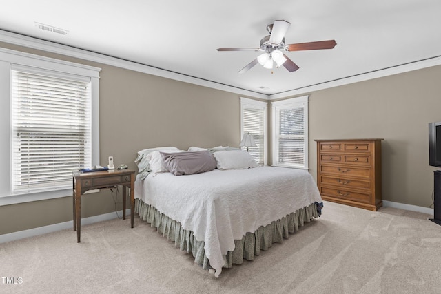 bedroom featuring visible vents, light carpet, baseboards, and crown molding