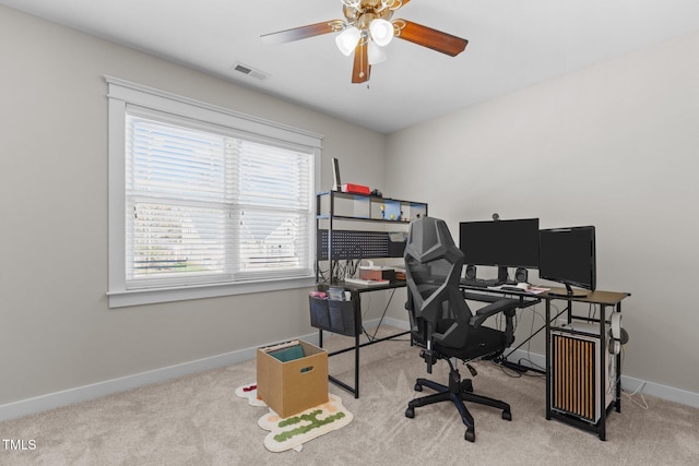 carpeted office with a ceiling fan, baseboards, and visible vents