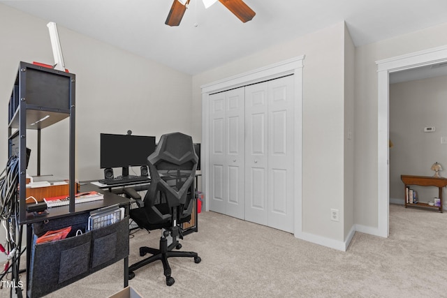 office space with carpet flooring, baseboards, lofted ceiling, and a ceiling fan