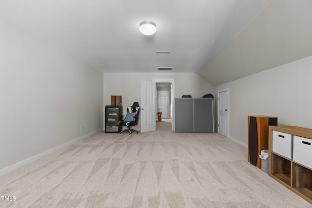 interior space featuring visible vents, baseboards, and vaulted ceiling