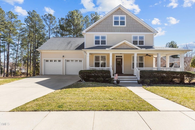 view of front of home with a garage, a front yard, a porch, and driveway