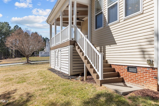 property entrance featuring crawl space, a lawn, and ceiling fan