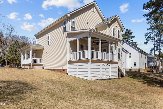 rear view of property with a porch, a lawn, and ceiling fan