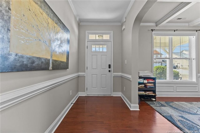 entryway featuring a wealth of natural light, ornamental molding, arched walkways, and wood finished floors