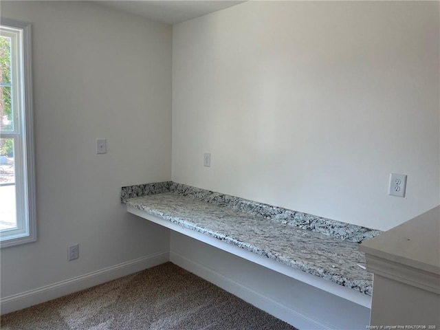 detailed view of carpet flooring and baseboards