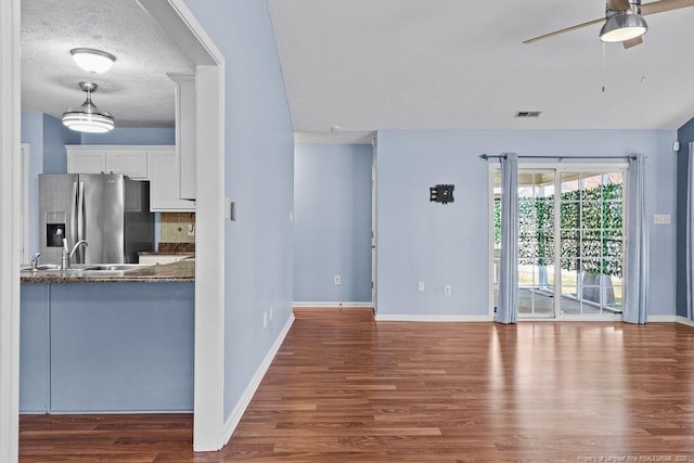 kitchen featuring wood finished floors, white cabinetry, ceiling fan, and stainless steel fridge with ice dispenser