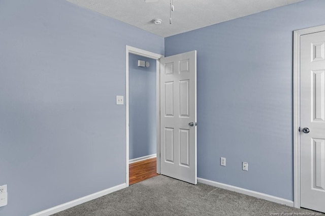 unfurnished bedroom with baseboards and carpet flooring