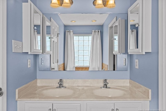 bathroom featuring a sink and double vanity