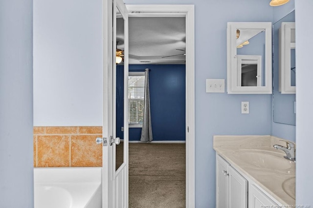 bathroom with vanity and a garden tub