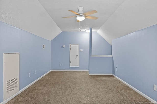 bonus room with lofted ceiling, carpet flooring, a ceiling fan, and baseboards