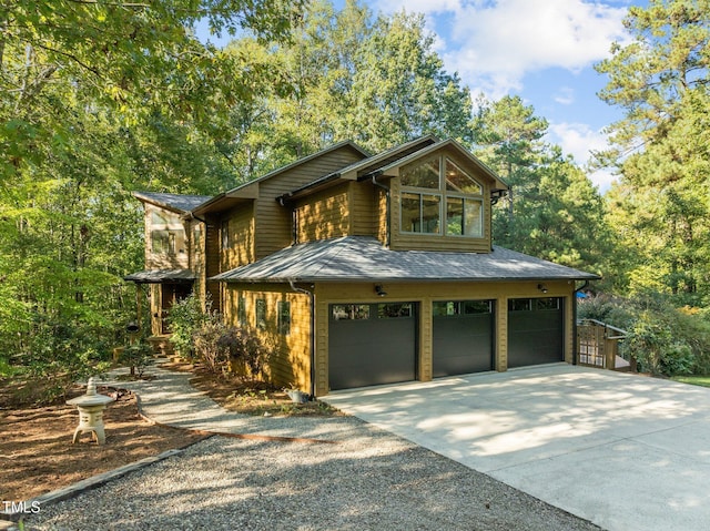 view of front of property with an attached garage and concrete driveway