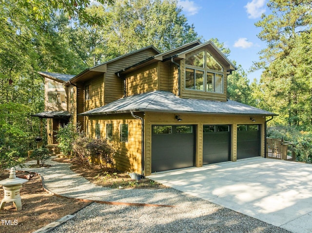 view of front of property featuring concrete driveway and a garage