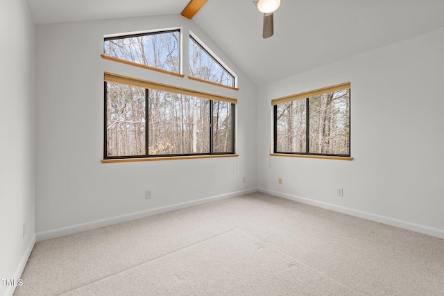 carpeted empty room with beam ceiling, baseboards, and ceiling fan