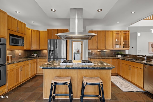 kitchen featuring a center island, a breakfast bar area, appliances with stainless steel finishes, island range hood, and a sink