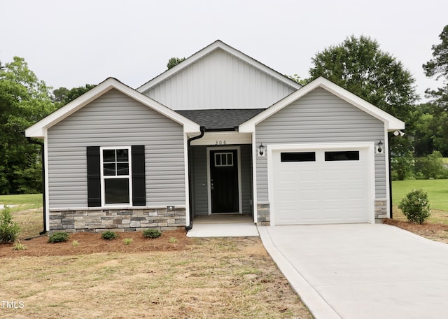 306 E Roseboro St, Roseboro, NC 28382 - view of front of home featuring stone siding, a garage, a shingled roof, concrete driveway, and a front lawn