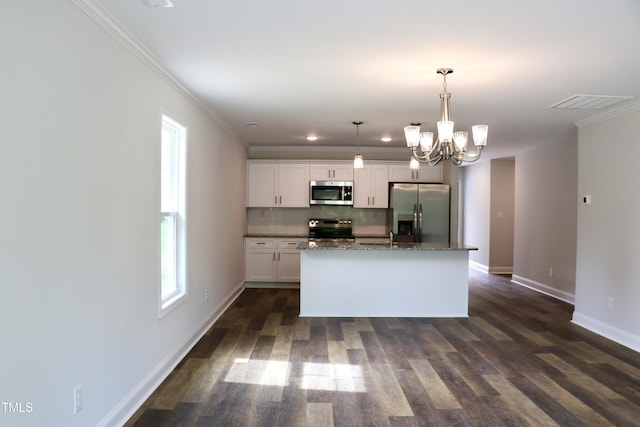 306 E Roseboro St, Roseboro, NC 28382 - kitchen with appliances with stainless steel finishes, a chandelier, baseboards, ornamental molding, and white cabinets