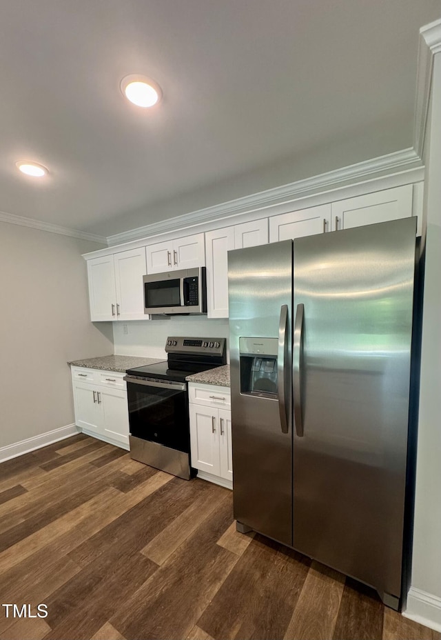 306 E Roseboro St, Roseboro, NC 28382 - kitchen featuring appliances with stainless steel finishes, light stone counters, dark wood finished floors, white cabinets, and crown molding