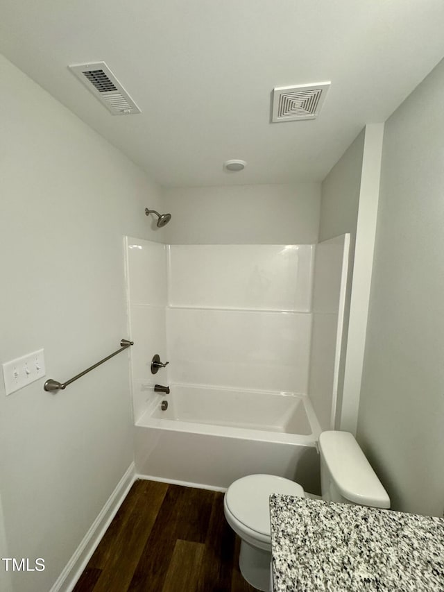 306 E Roseboro St, Roseboro, NC 28382 - bathroom featuring toilet, wood finished floors,  shower combination, and baseboards