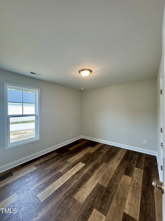 306 E Roseboro St, Roseboro, NC 28382 - spare room featuring dark wood-style flooring and baseboards