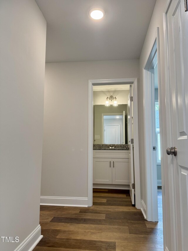 306 E Roseboro St, Roseboro, NC 28382 - hallway featuring dark wood-type flooring, baseboards, and a sink