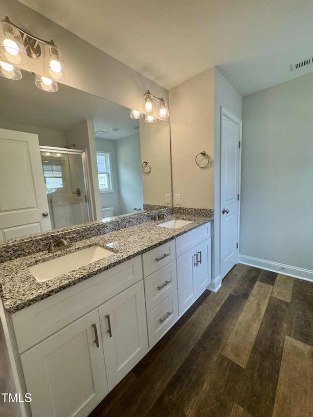 306 E Roseboro St, Roseboro, NC 28382 - full bathroom with a shower stall, wood finished floors, double vanity, and baseboards