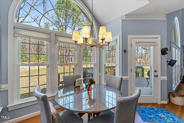 sunroom featuring a notable chandelier and a healthy amount of sunlight