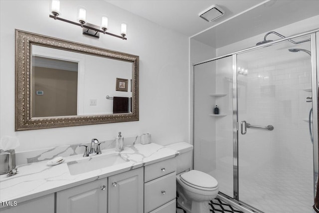 bathroom with vanity, toilet, and a stall shower