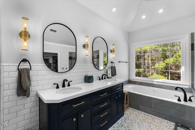 full bath featuring a sink, lofted ceiling, a bath, and double vanity