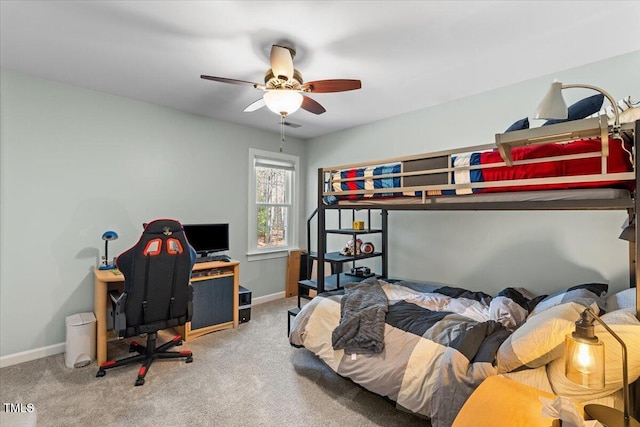 carpeted bedroom with a ceiling fan and baseboards