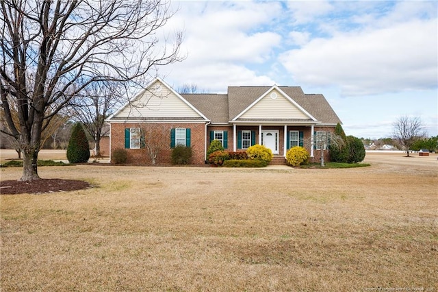 view of front facade featuring brick siding and a front lawn