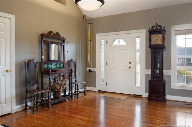 entryway with visible vents, wood finished floors, and baseboards