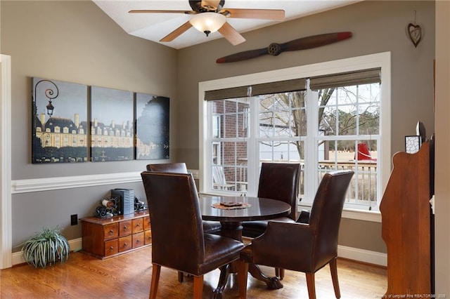 dining area with baseboards, a ceiling fan, and wood finished floors