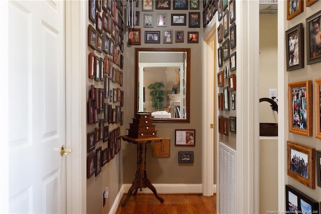 hall with wood finished floors and baseboards