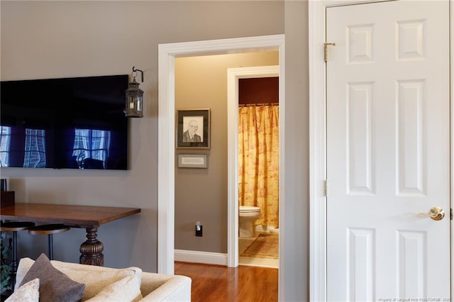 interior space featuring wood finished floors and baseboards