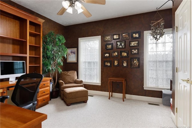 home office featuring visible vents, baseboards, a ceiling fan, and carpet floors