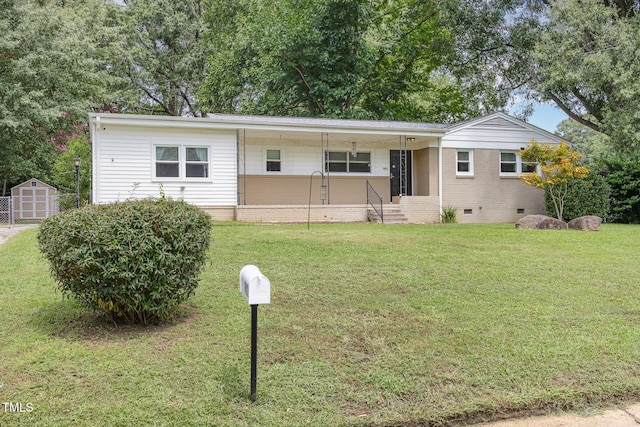 ranch-style house with an outbuilding, a front yard, a shed, entry steps, and crawl space