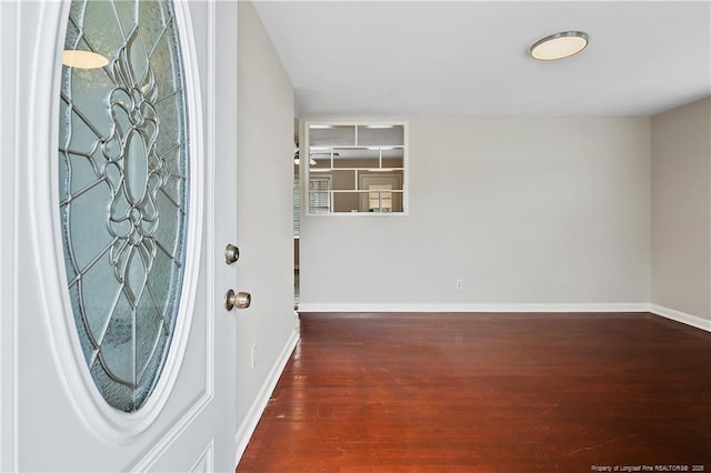 entryway featuring wood finished floors and baseboards