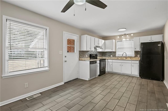 kitchen featuring visible vents, under cabinet range hood, black appliances, a ceiling fan, and a sink