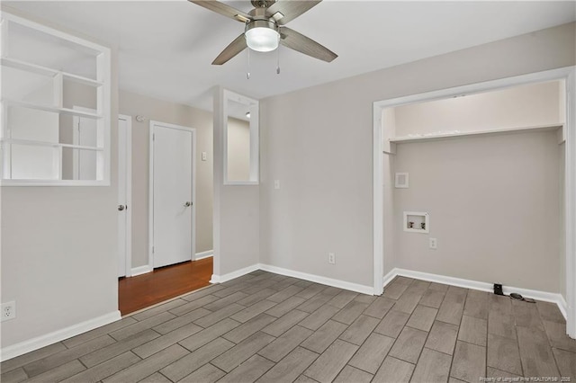 spare room featuring baseboards, a ceiling fan, and wood finished floors