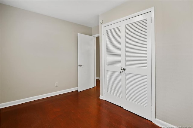 unfurnished bedroom featuring baseboards and a closet