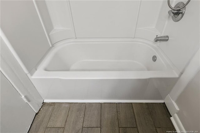 bathroom featuring a bathtub and wood finished floors