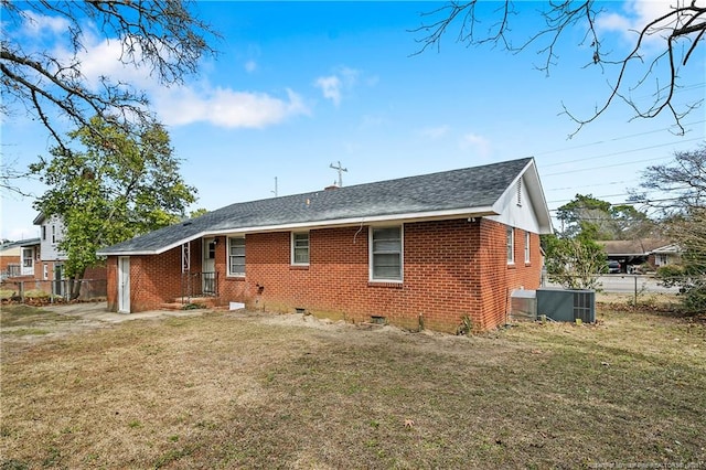 back of house featuring brick siding, fence, central AC, a yard, and crawl space