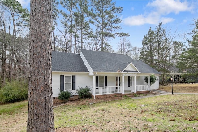 ranch-style home with a shingled roof, a front lawn, covered porch, and crawl space