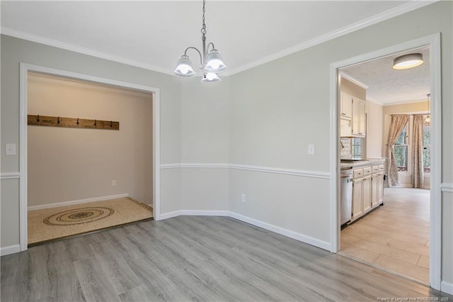 unfurnished dining area with crown molding, baseboards, light wood finished floors, and a chandelier