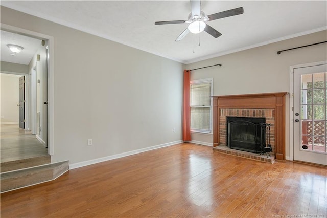 unfurnished living room with ornamental molding, ceiling fan, baseboards, and wood finished floors