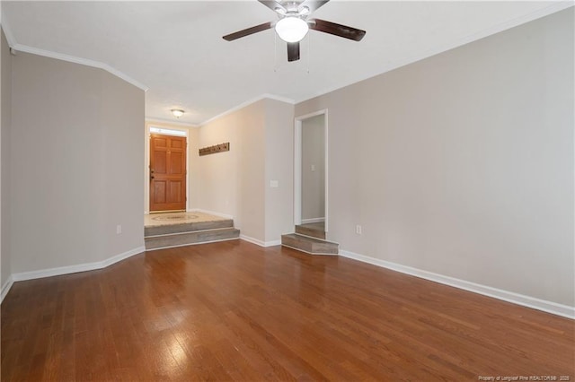 unfurnished room featuring ornamental molding, baseboards, ceiling fan, and wood finished floors